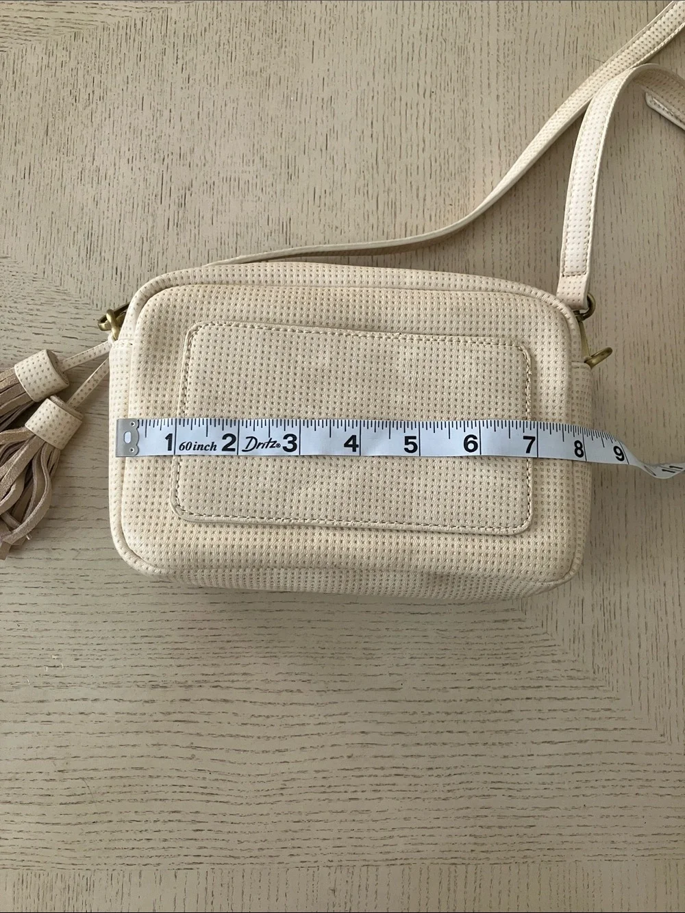 Anthropologie Cream Perforated Crossbody Camera Bag with Tassel
